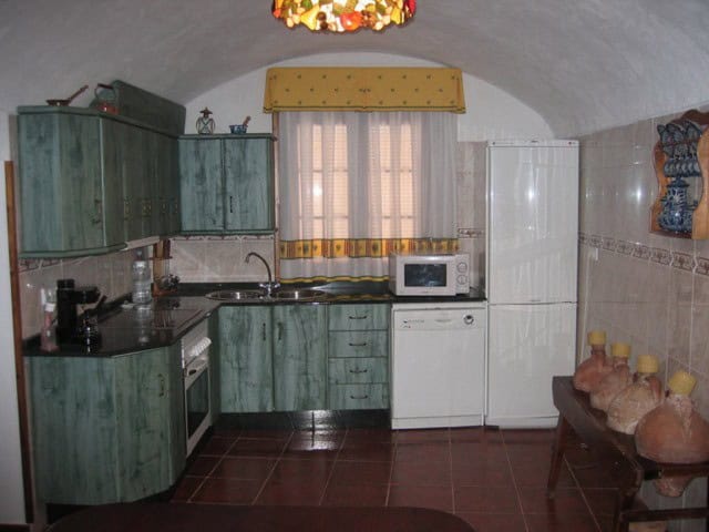 Farm property kitchen in Cullar, Granada with rustic decor and traditional features.