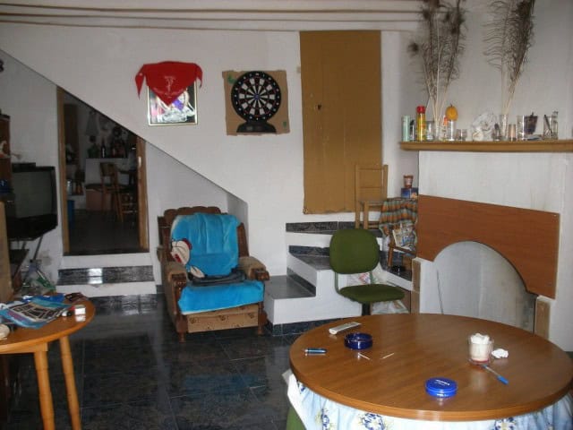 Interior view of a rustic rural property in Velez Blanco, Almeria, showing a living area with furnit.