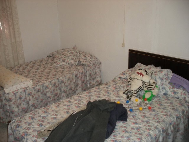 Charming rural property bedroom in Velez Blanco, Almeria, featuring simple furnishings and cozy deco.