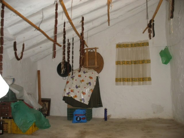 Traditional rural property interior with hanging tools and rustic decor in Velez Blanco, Almeria.