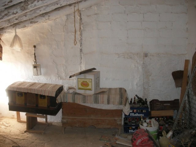 Traditional rural home interior in Velez Blanco, Almeria, with rustic furniture and storage boxes.