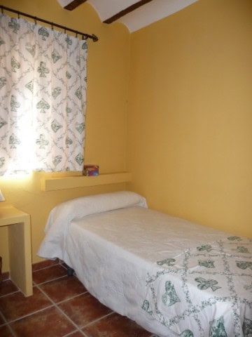 Charming bedroom in village property, Belerda, Jaen, with cozy decor and natural light.