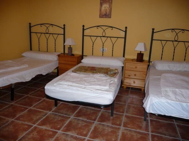 Village property bedroom with three single beds in Belerda, Jaen.