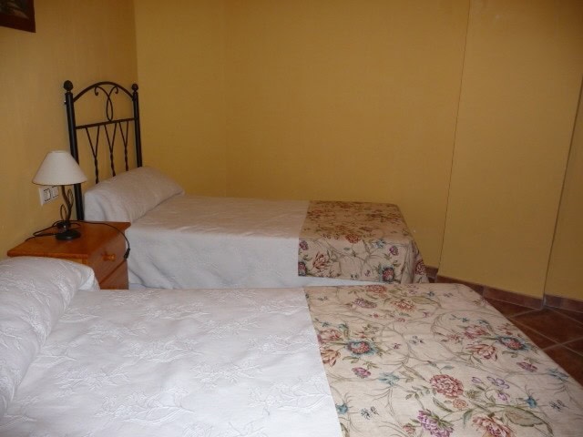 Comfortable twin beds with floral bedspreads in a charming village setting.