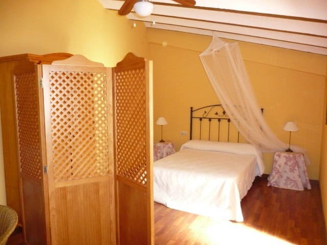Charming village property in Belerda, Jaen with cozy bedroom and rustic decor.