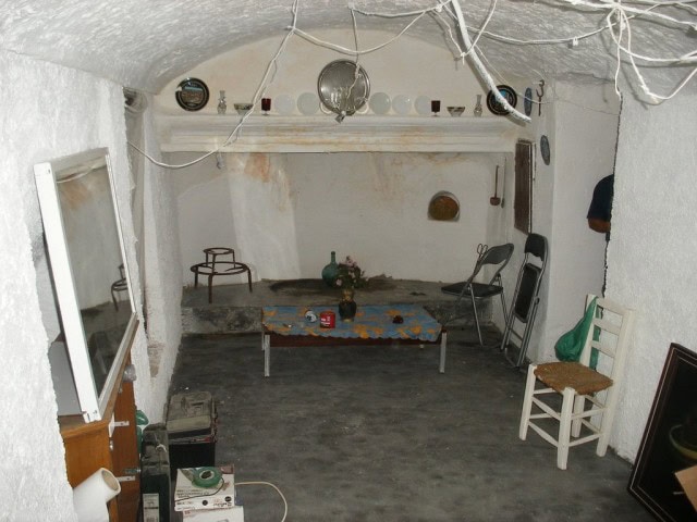 Cave house interior in Cuevas del Campo, Granada, featuring rustic decor and unique architecture.