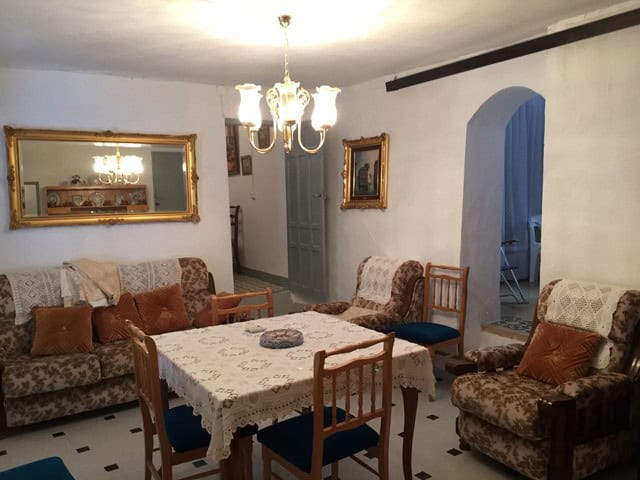 Cozy living room with traditional furniture and elegant decor in a village property in Orce, Granada.
