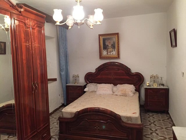 Charming bedroom in a traditional village property in Orce, Granada, featuring classic wooden furnit.