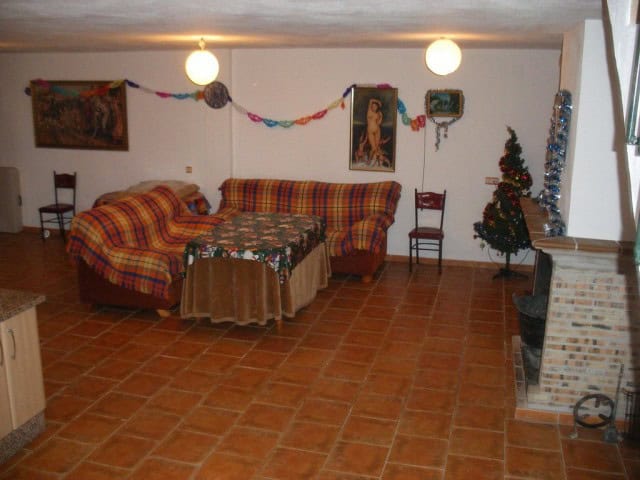 Charming rural property living room with festive decorations in Freila, Granada, featuring a firepla.
