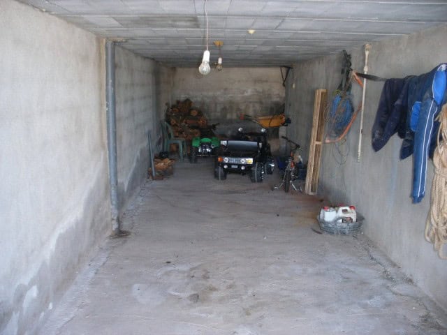Garage space for vehicles and storage in rural Granada property.