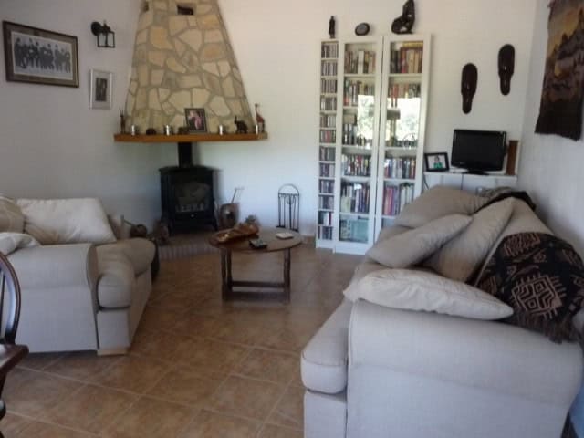 Charming living room in a rural property in Castril, Granada, featuring cozy seating, a fireplace, a.