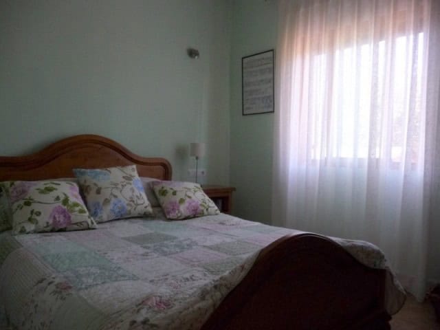 Rural property bedroom in Castril, Granada with natural light and cozy decor.