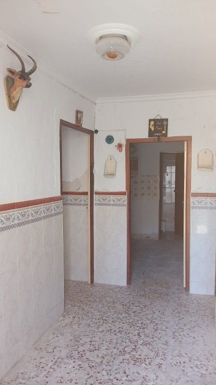 Interior view of a village property entrance in Larva, Jaen, with traditional decor and rustic charm.