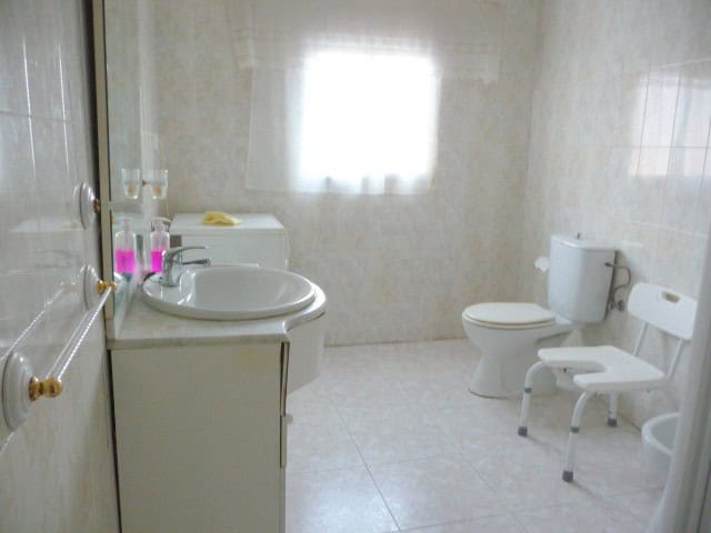 Charming village property bathroom in Belerda, Jaen with accessible features and natural light.
