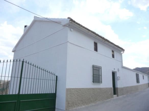 Charming white village house in Belerda, Jaen, with traditional architecture and scenic surroundings.