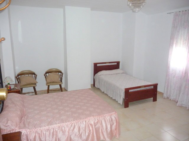 Village property bedroom with two beds in Belerda, Jaen, Spain.