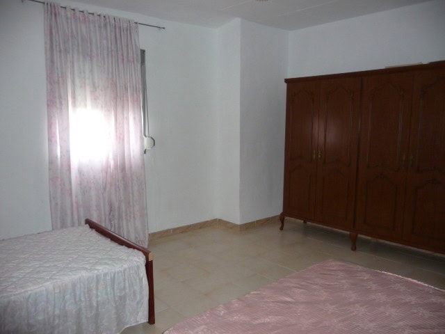 Charming village property in Belerda, Jaen, featuring a simple interior with a bed, wardrobe, and na.