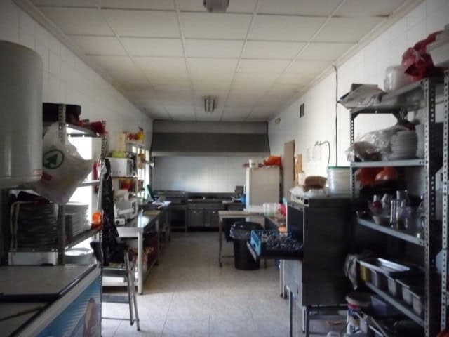Commercial kitchen for sale in Benamaurel, Granada, with modern appliances and ample storage space.