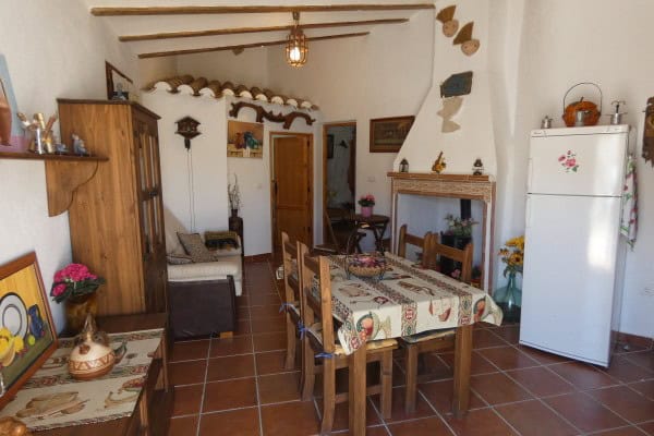 Cave house interior in Galera, Granada, featuring rustic decor and traditional furnishings.