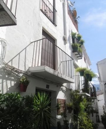 Charming village house with balconies and lush plants in Quesada, Jaen.