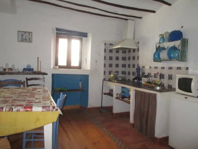 Cozy traditional kitchen in a village property in Quesada, Jaen, featuring rustic decor and essentia.