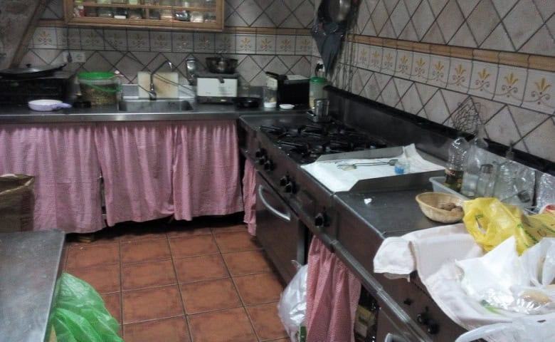 Kitchen in Gor, Granada with stove, utensils, and storage area.