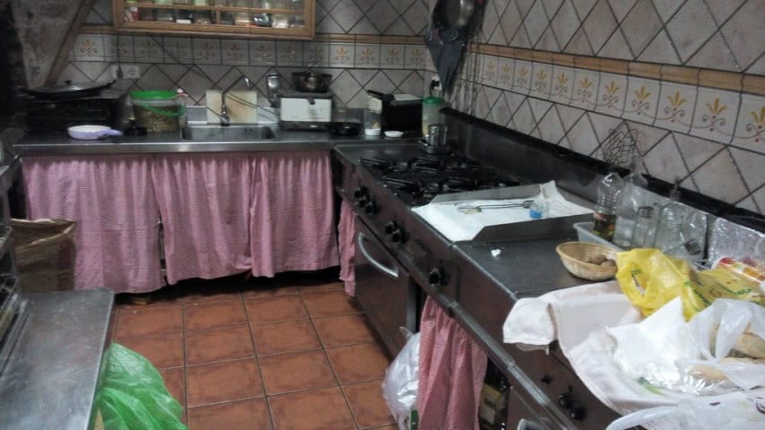 Kitchen in Gor, Granada with stove, utensils, and storage area.