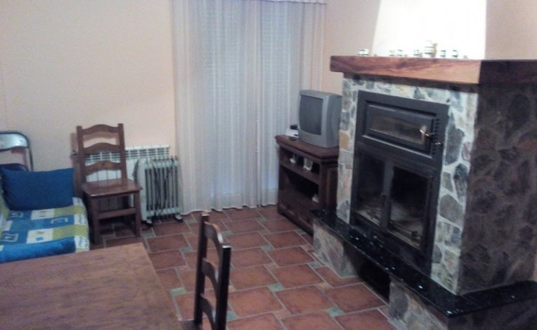 Living room with fireplace and seating area in Gor, Granada.