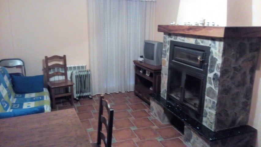 Living room with fireplace and seating area in Gor, Granada.