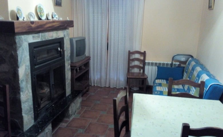 Interior view of a living room in Gor, Granada with fireplace and seating area.
