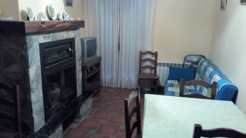 Interior view of a living room in Gor, Granada with fireplace and seating area.