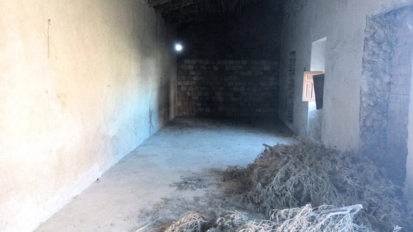 Ancient ruin in Cuevas del Campo, Granada, showcasing historical stone walls and an open doorway.