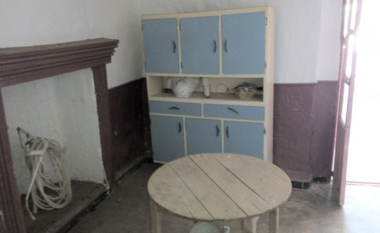 Charming cave house interior in Freila, Granada, featuring rustic furniture and cozy living space.