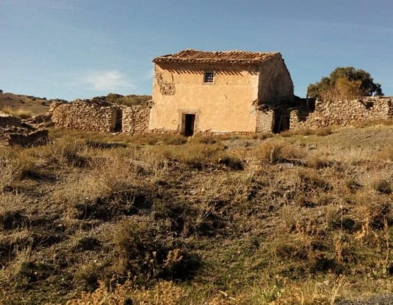 Rustic farm property in Gor, Granada, featuring traditional architecture and expansive land.