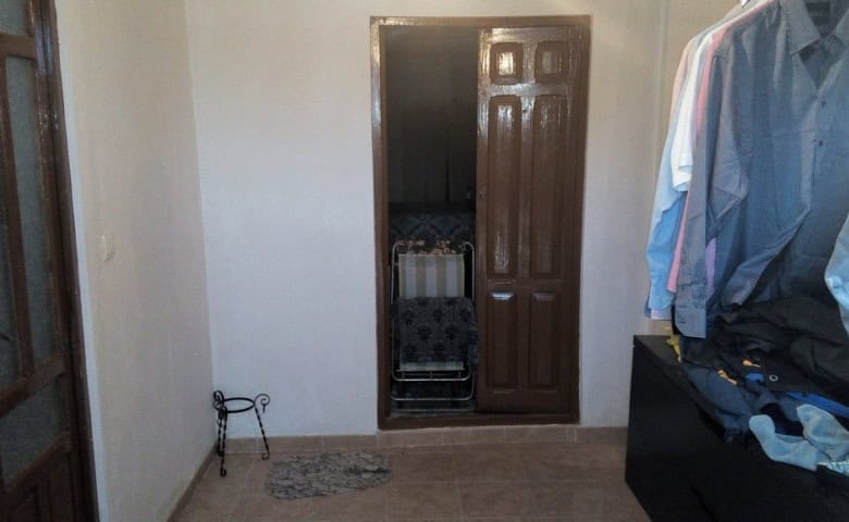 Interior view of the Cave House in Pulpite, Granada, showcasing simple decor and compact space.