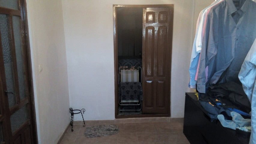 Interior view of the Cave House in Pulpite, Granada, showcasing simple decor and compact space.