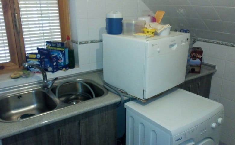Charming cave house kitchen in Pulpite, Granada, featuring a compact sink, microwave, and essential.