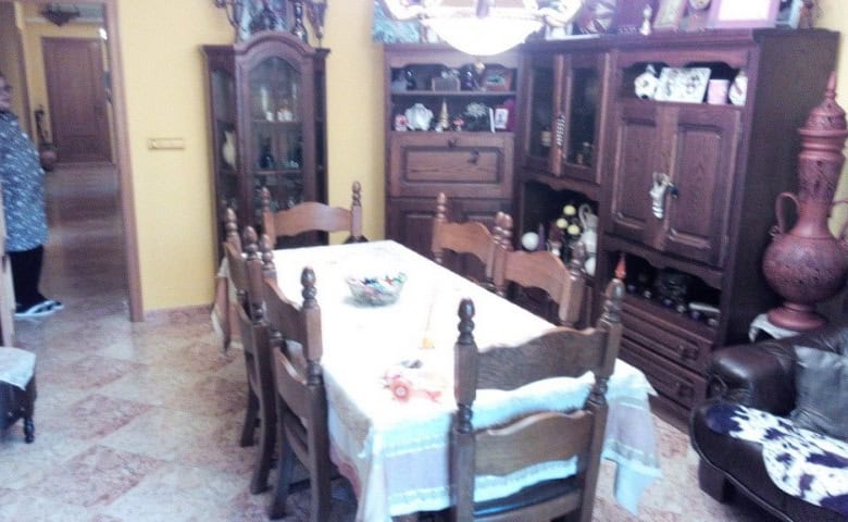 Apartment in Baza, Granada with traditional wooden furniture and cozy dining area.