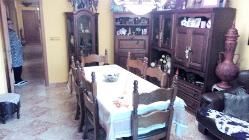 Apartment in Baza, Granada with traditional wooden furniture and cozy dining area.