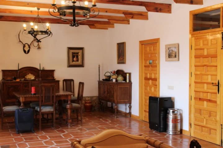 Charming interior of a finca in Larva, Jaen with rustic wooden beams and traditional decor.
