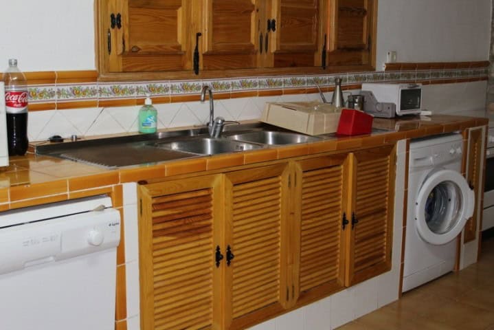 Charming kitchen in a rural finca located in Larva, Jaen, featuring wooden cabinets and modern appli.