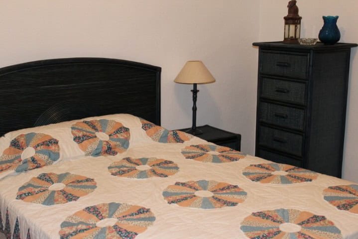 Charming bedroom in a rural finca in Larva, Jaen, featuring a cozy bed, bedside lamp, and rustic dec.