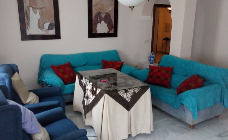 Cozy living room in a modern apartment in Baza, Granada with colorful sofas and stylish decor.