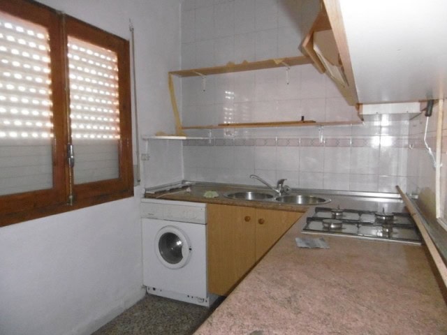 Cozy kitchen in a village property in Cuenca, Jaen with basic appliances and natural light.