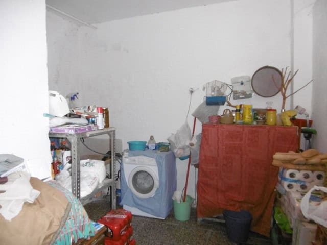 Interior of a village house in Cuenca, Jaen, showing simple furnishings and household essentials.
