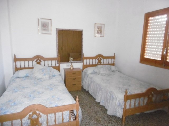 Charming village property in Cuenca, Jaen with two bedrooms and traditional wooden furniture.