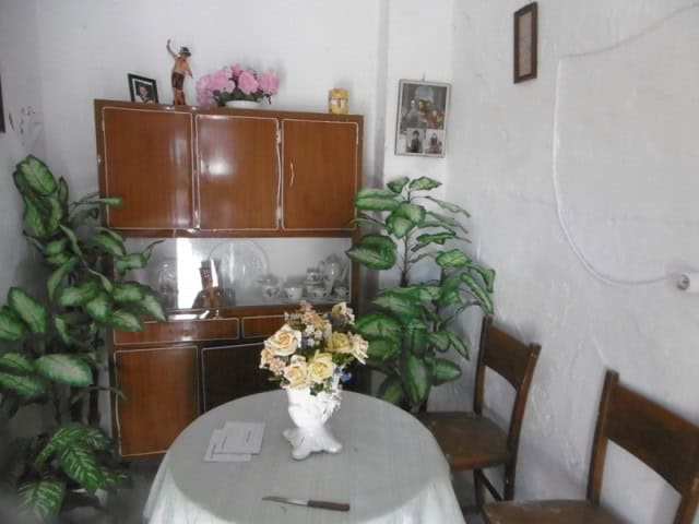 Charming village home interior with vintage furniture and decorative plants in Belerda, Jaen.