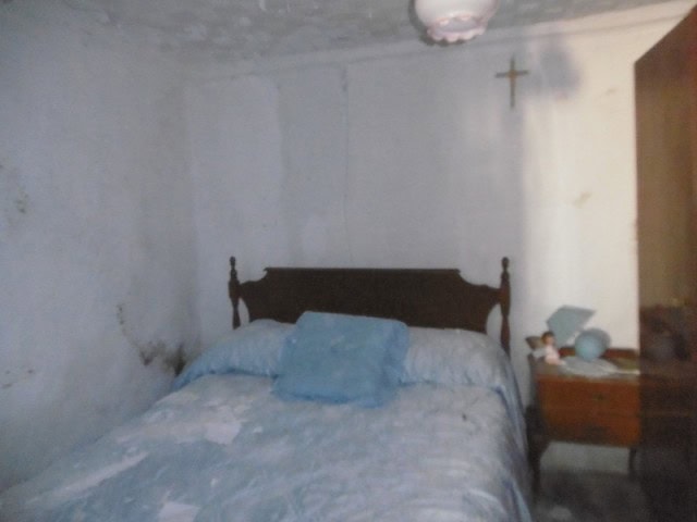 Charming bedroom in Belerda village with rustic decor and simple furnishings.