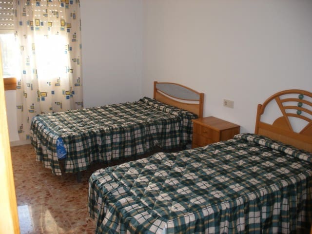 Apartment in Cuevas del Campo, Granada with two single beds and simple furnishings.
