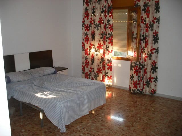 Comfortable bedroom with natural light in Cuevas del Campo, Granada. Perfect for relaxing stays in t.